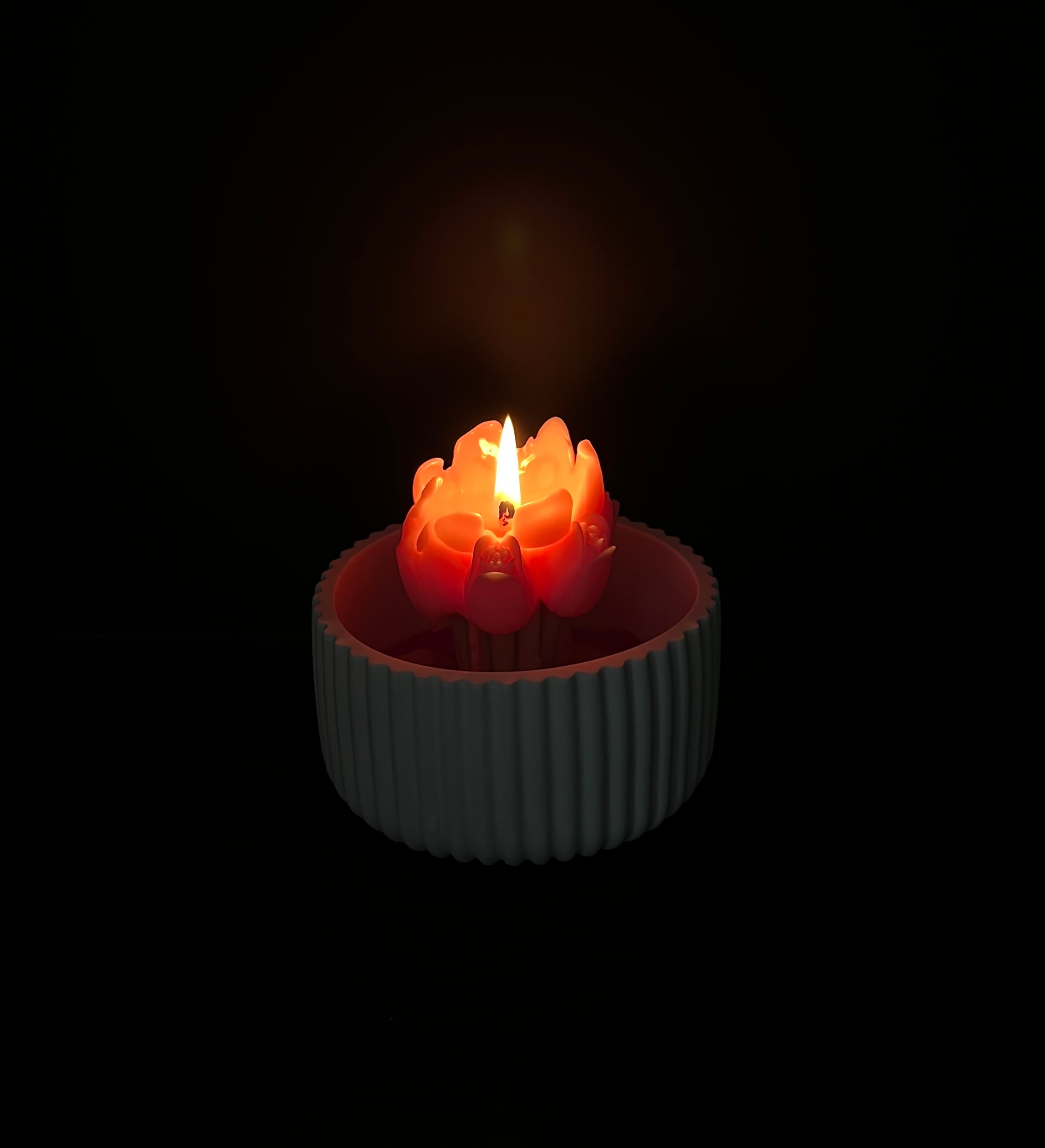 A customer’s lit lotus flower candle