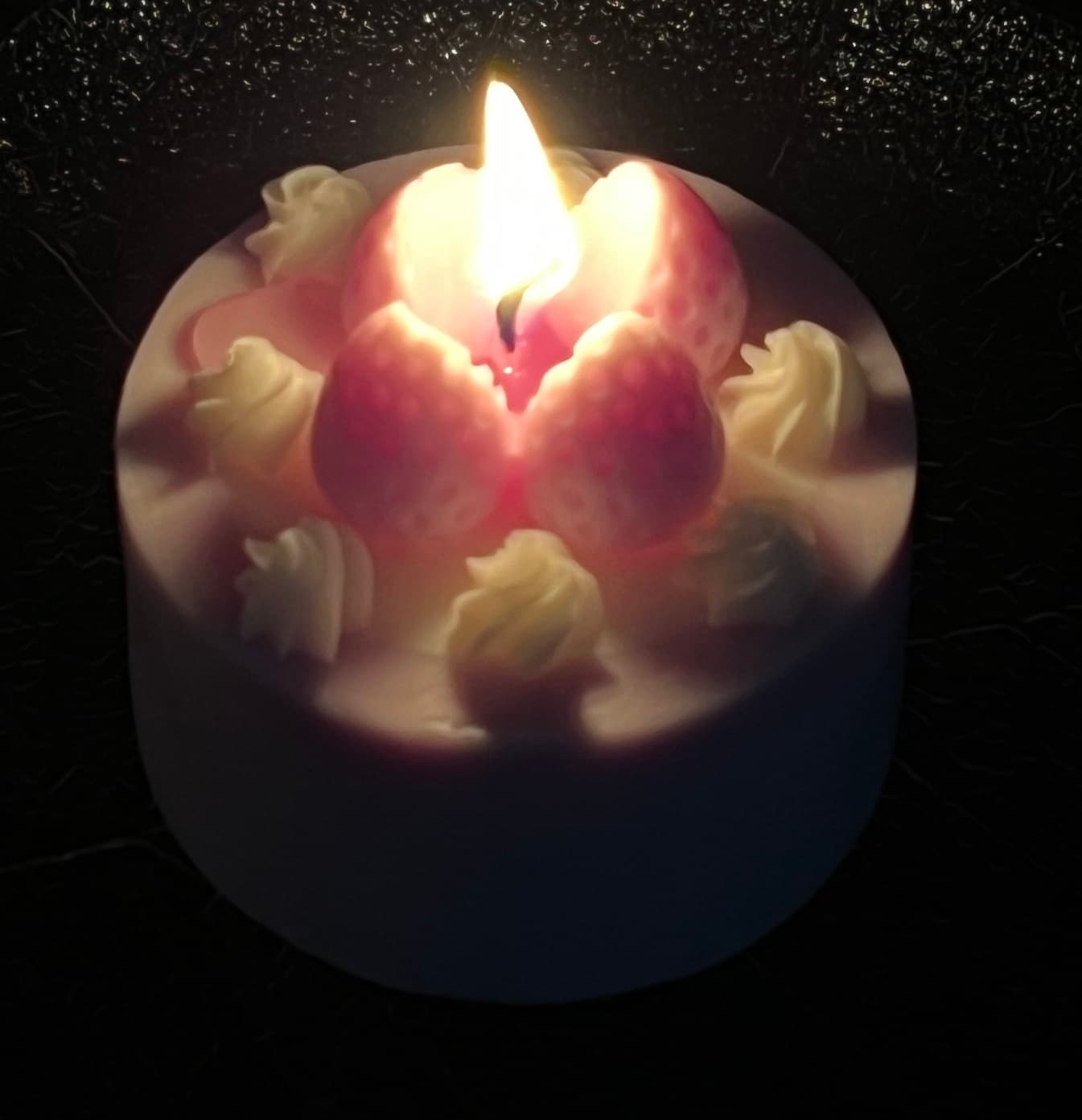 A customer’s lit strawberry cake candle