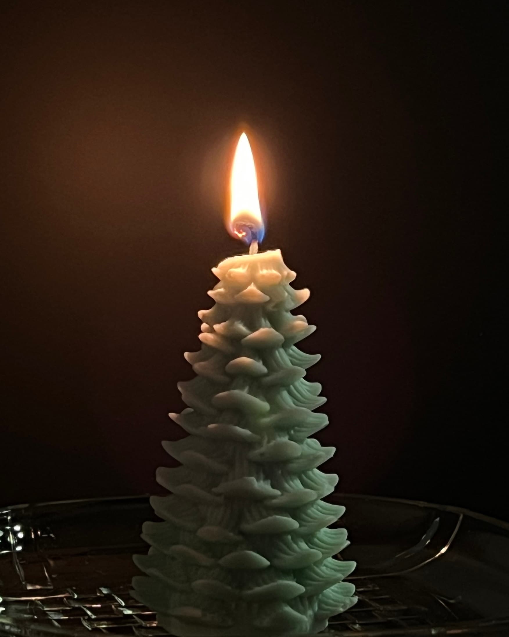 A customer’s lit pine tree candle